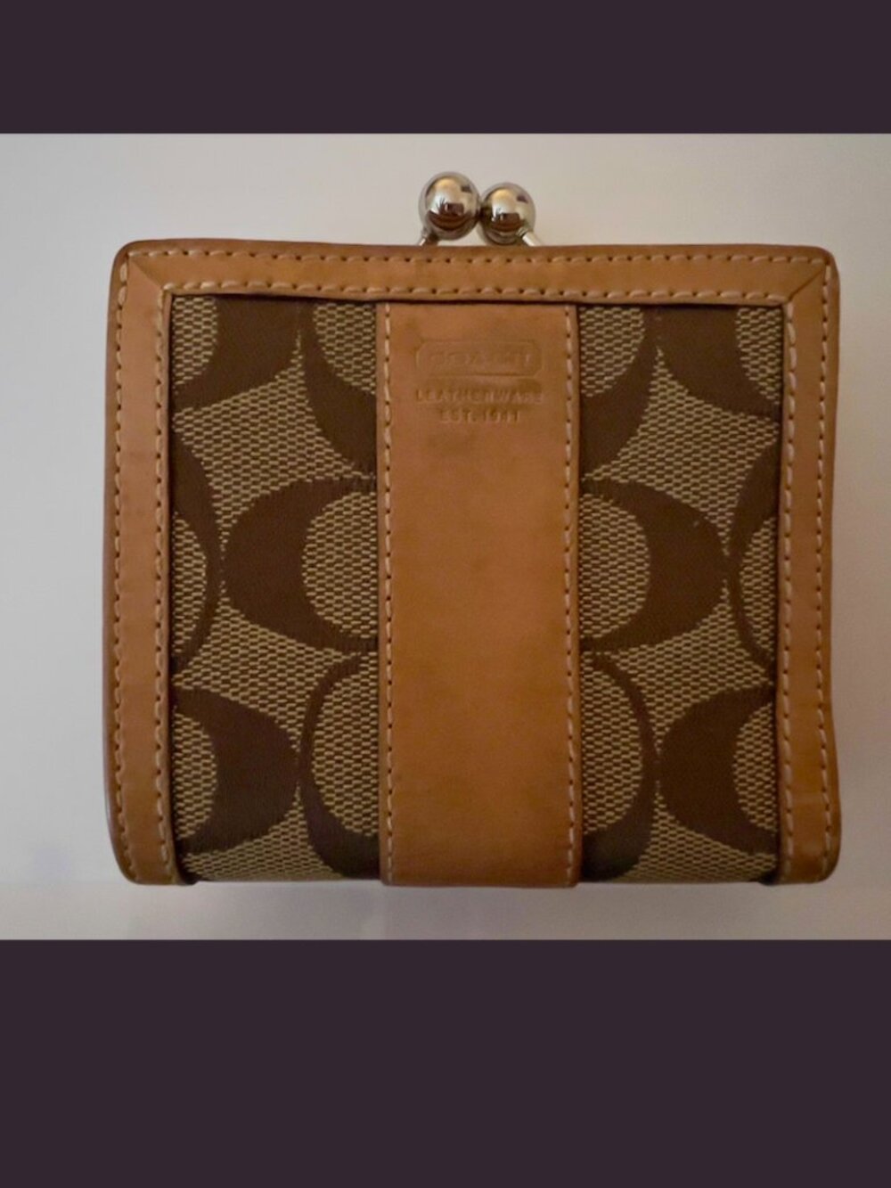 COACH vintage bi-fold wallet featuring the brand's signature kisslock coin purse